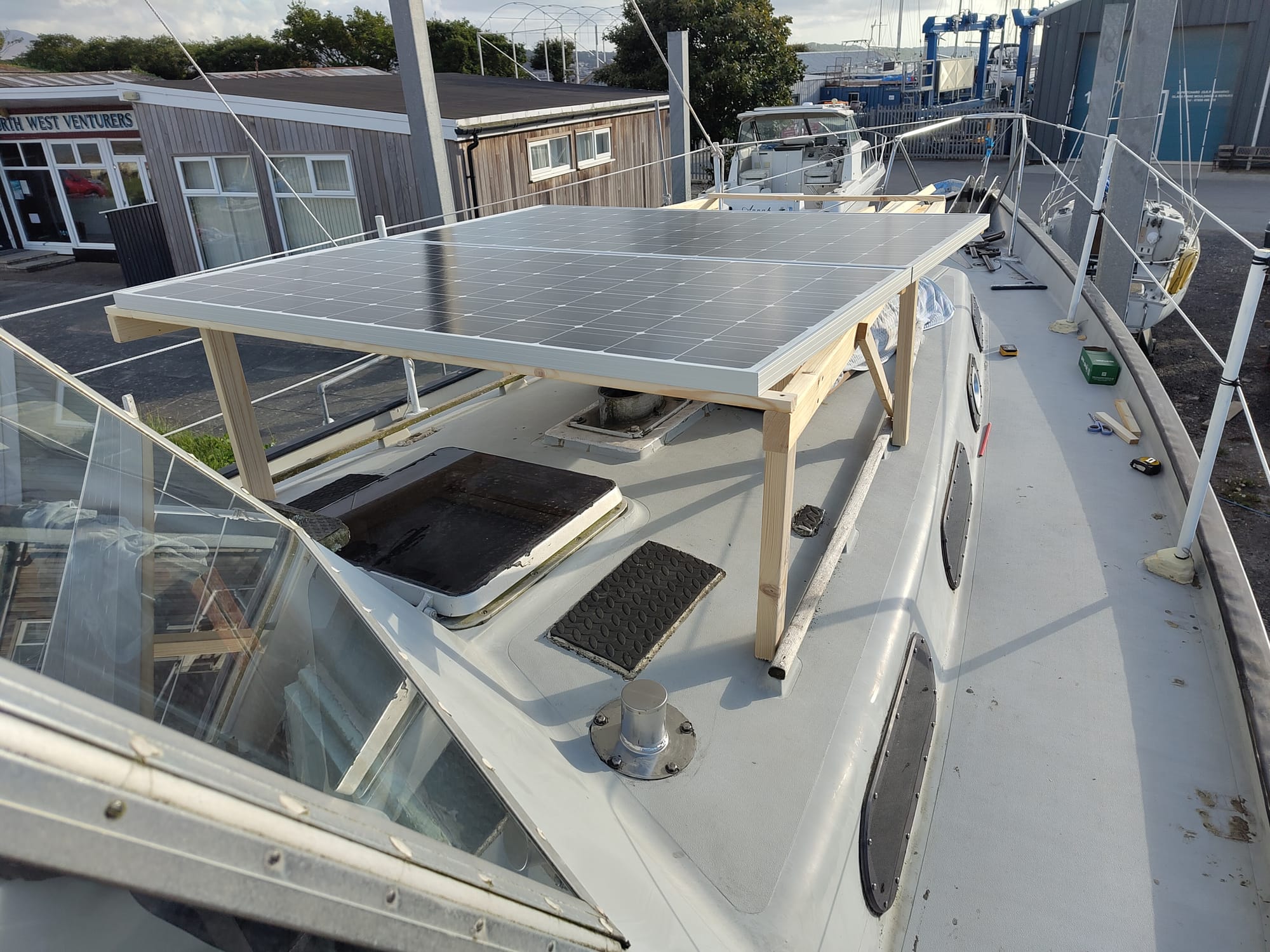 Looking forward from outside the wheelhouse showing the two solar panels on a timber frame that will be used as a wood store